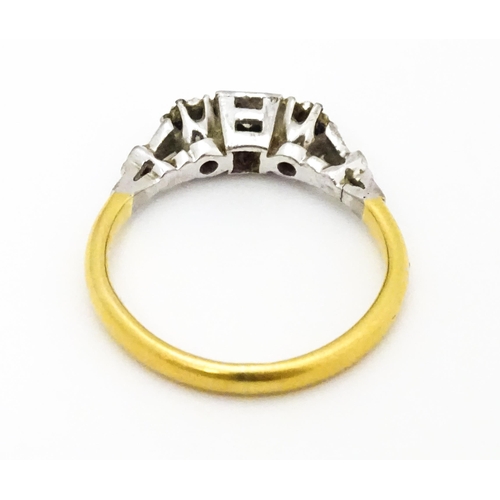 675 - A gold ring set with trio of diamonds. Ring size approx. H 1/2