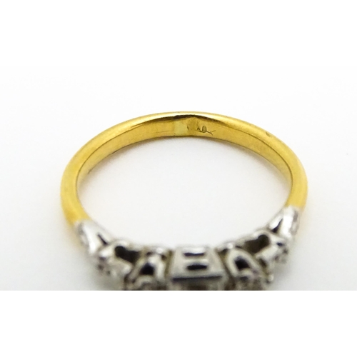 675 - A gold ring set with trio of diamonds. Ring size approx. H 1/2