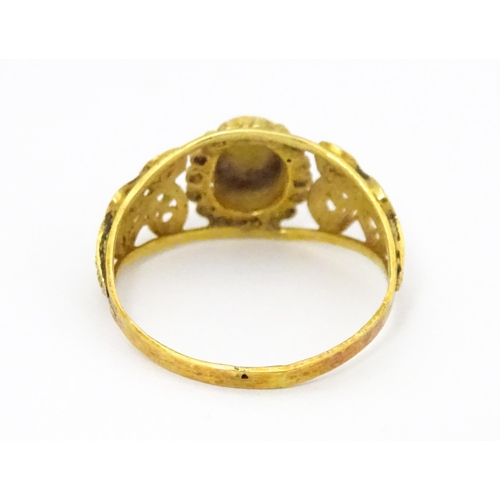 680 - A yellow metal ring with filigree decoration. Ring size approx. K 1/2