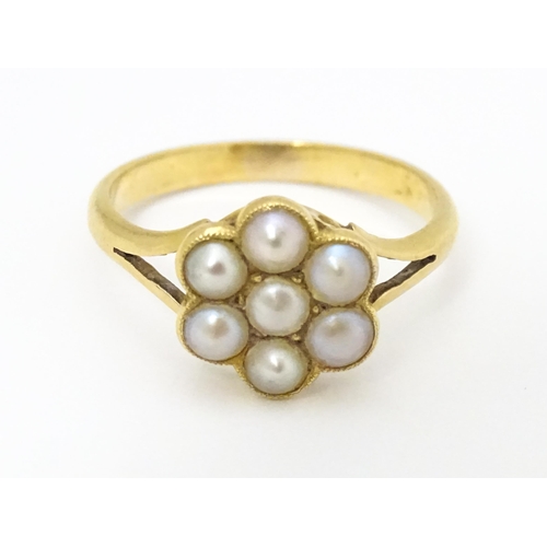 681 - A yellow metal ring set with seed pearls. Ring size approx. M 1/2