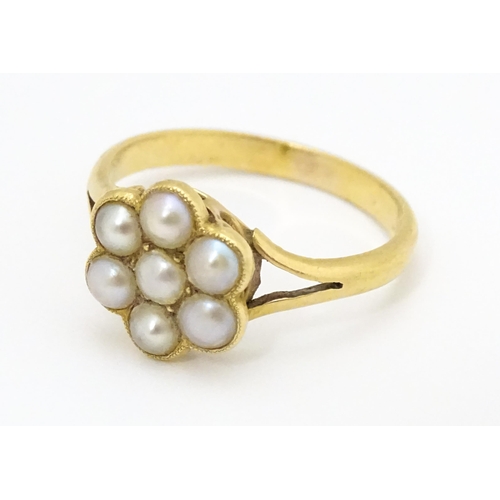 681 - A yellow metal ring set with seed pearls. Ring size approx. M 1/2