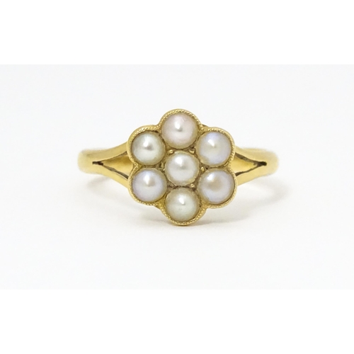 681 - A yellow metal ring set with seed pearls. Ring size approx. M 1/2