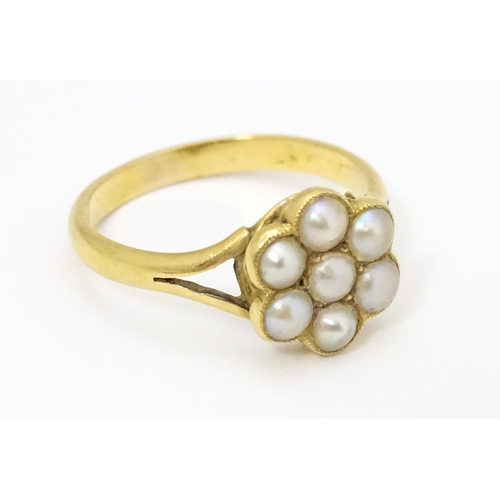 681 - A yellow metal ring set with seed pearls. Ring size approx. M 1/2