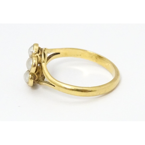 681 - A yellow metal ring set with seed pearls. Ring size approx. M 1/2