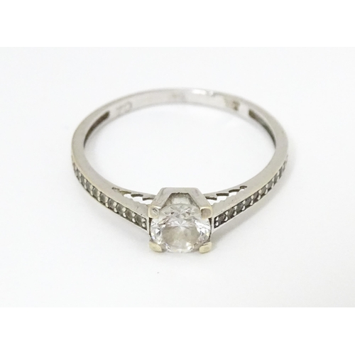 684 - A 9ct white gold ring set with cubic zirconia. Ring size approx. S