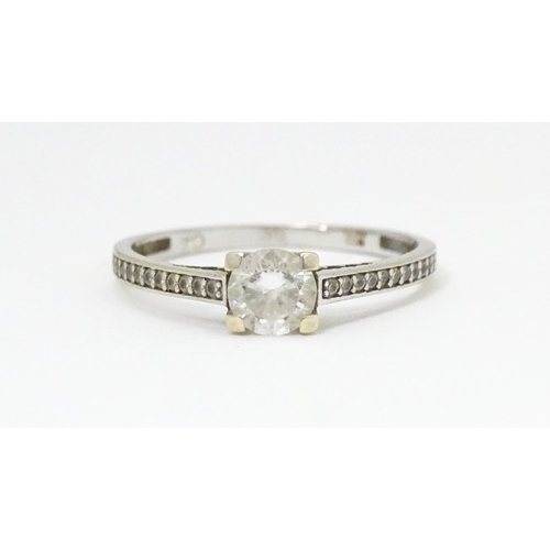 684 - A 9ct white gold ring set with cubic zirconia. Ring size approx. S