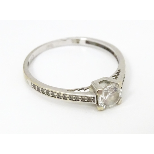 684 - A 9ct white gold ring set with cubic zirconia. Ring size approx. S