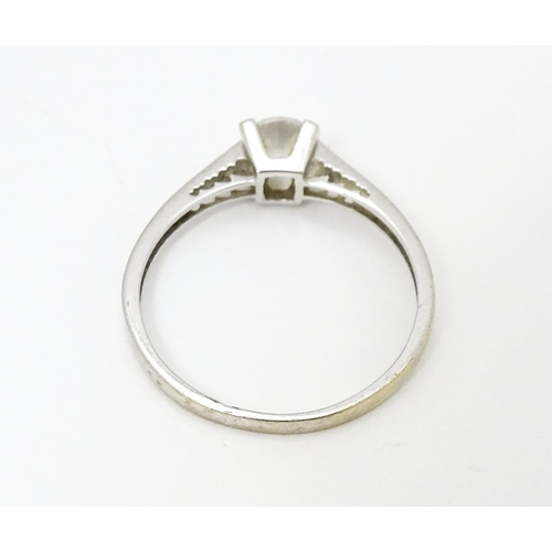 684 - A 9ct white gold ring set with cubic zirconia. Ring size approx. S