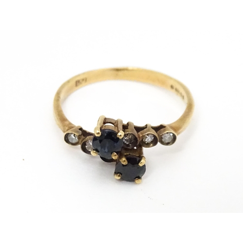 686 - A 9ct gold ring set with sapphires and diamonds. Ring size approx. L