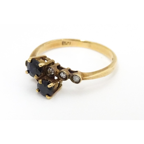 686 - A 9ct gold ring set with sapphires and diamonds. Ring size approx. L