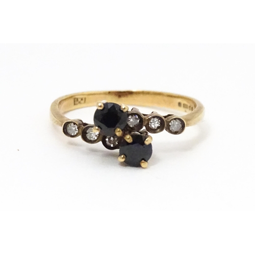 686 - A 9ct gold ring set with sapphires and diamonds. Ring size approx. L