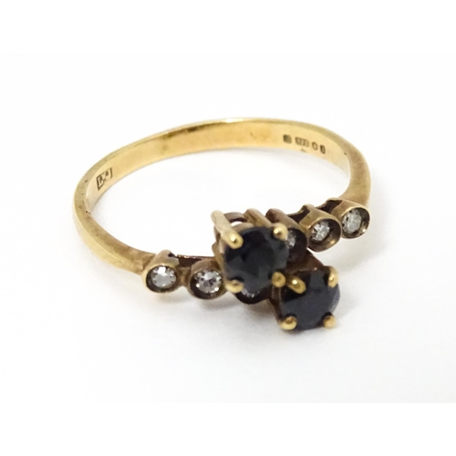 686 - A 9ct gold ring set with sapphires and diamonds. Ring size approx. L