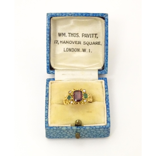 693 - A Victorian 12ct gold ring set with garnet and pearl hallmarked Birmingham 1857. Maker J.A  Ring siz... 