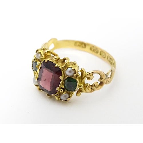 693 - A Victorian 12ct gold ring set with garnet and pearl hallmarked Birmingham 1857. Maker J.A  Ring siz... 