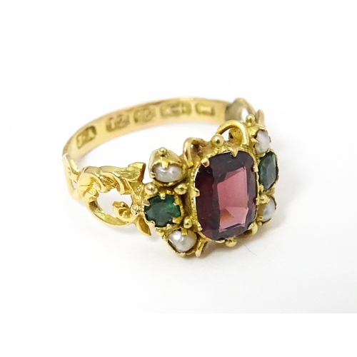 693 - A Victorian 12ct gold ring set with garnet and pearl hallmarked Birmingham 1857. Maker J.A  Ring siz... 