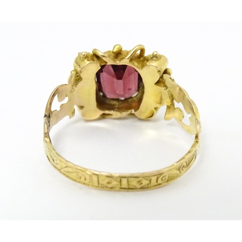 693 - A Victorian 12ct gold ring set with garnet and pearl hallmarked Birmingham 1857. Maker J.A  Ring siz... 