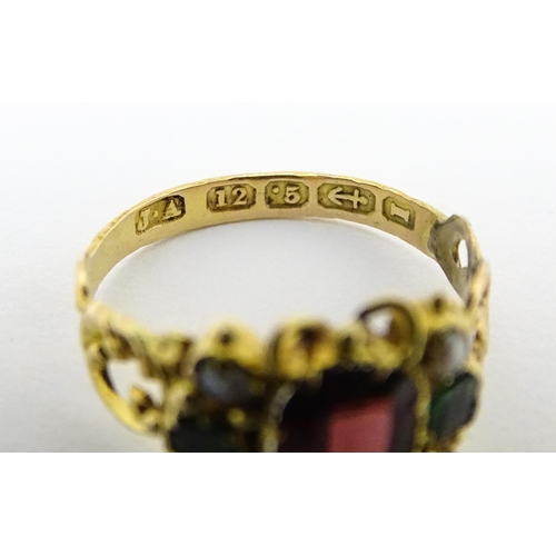 693 - A Victorian 12ct gold ring set with garnet and pearl hallmarked Birmingham 1857. Maker J.A  Ring siz... 