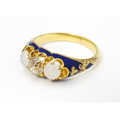 694 - A 19thC yellow gold ring set with central diamond flanked by opals in a blue enamel setting. Ring si... 