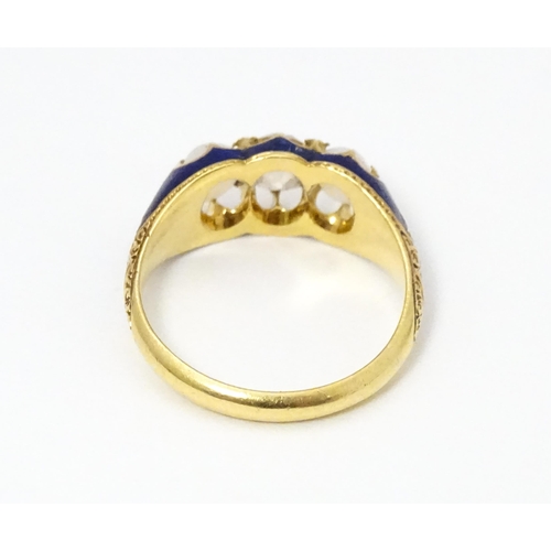 694 - A 19thC yellow gold ring set with central diamond flanked by opals in a blue enamel setting. Ring si... 