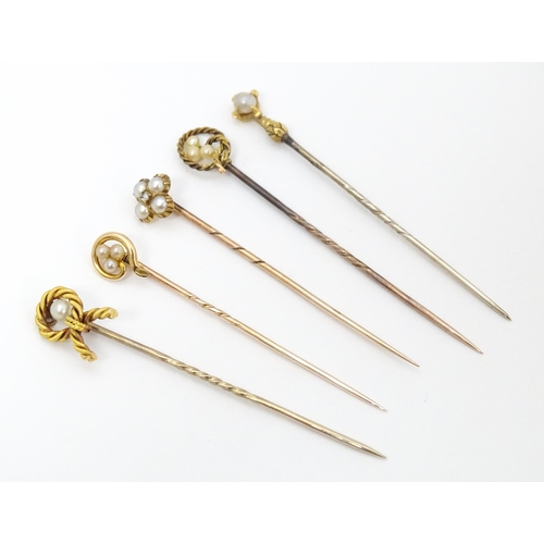 700 - Five assorted gold and gilt metal stick pins set with seed pearls, to include an example stamped 15c... 