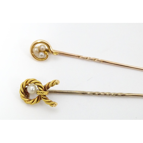 700 - Five assorted gold and gilt metal stick pins set with seed pearls, to include an example stamped 15c... 