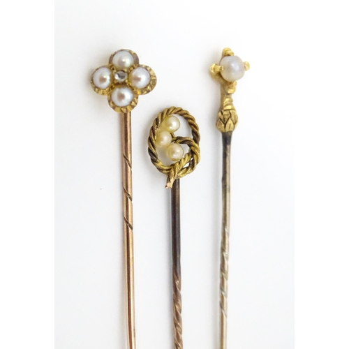 700 - Five assorted gold and gilt metal stick pins set with seed pearls, to include an example stamped 15c... 