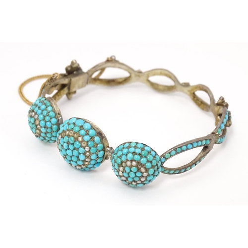 701 - A white metal bracelet set with turquoise and seed pearl. Indistinctly marked.  Possibly Russian.