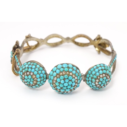 701 - A white metal bracelet set with turquoise and seed pearl. Indistinctly marked.  Possibly Russian.