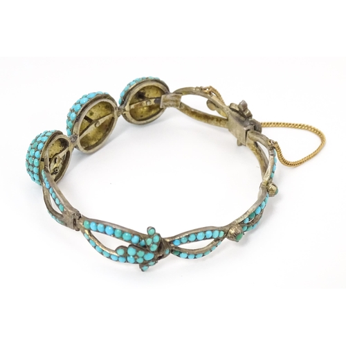 701 - A white metal bracelet set with turquoise and seed pearl. Indistinctly marked.  Possibly Russian.