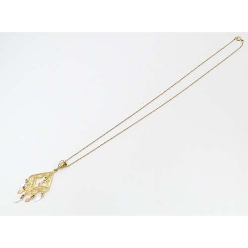 704 - A 9ct gold pendant with filigree detail on a 9ct gold chain. The pendant approx 2