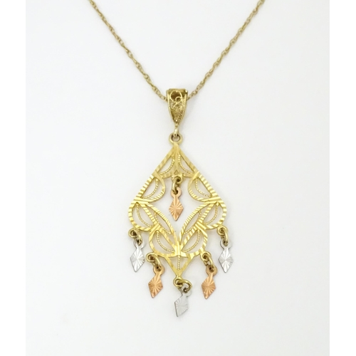 704 - A 9ct gold pendant with filigree detail on a 9ct gold chain. The pendant approx 2