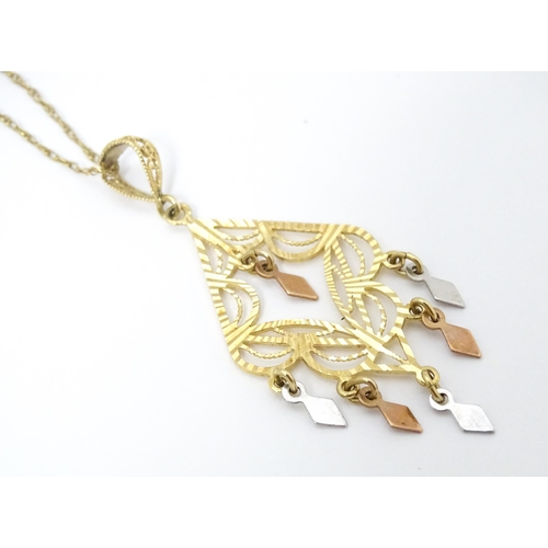 704 - A 9ct gold pendant with filigree detail on a 9ct gold chain. The pendant approx 2