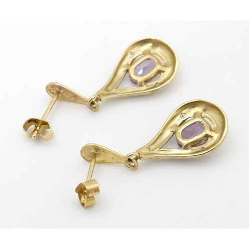 708 - Yellow metal drop earrings set with amethyst and chip set diamonds. Approx 1