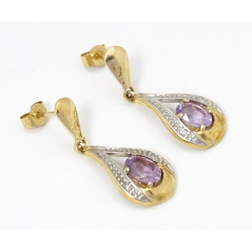 708 - Yellow metal drop earrings set with amethyst and chip set diamonds. Approx 1