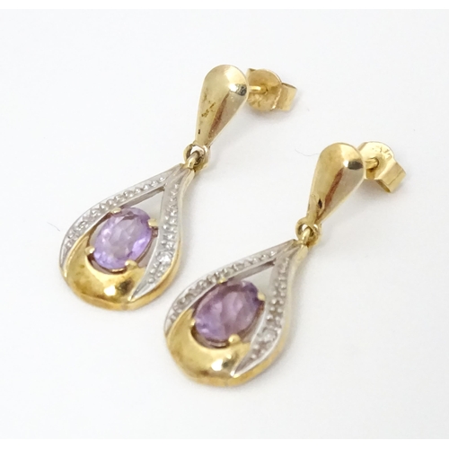 708 - Yellow metal drop earrings set with amethyst and chip set diamonds. Approx 1