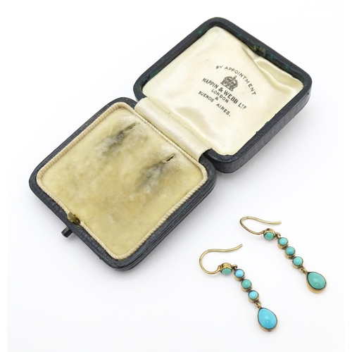 713 - A pair of gold drop earrings set with turquoise. 1 1 /4