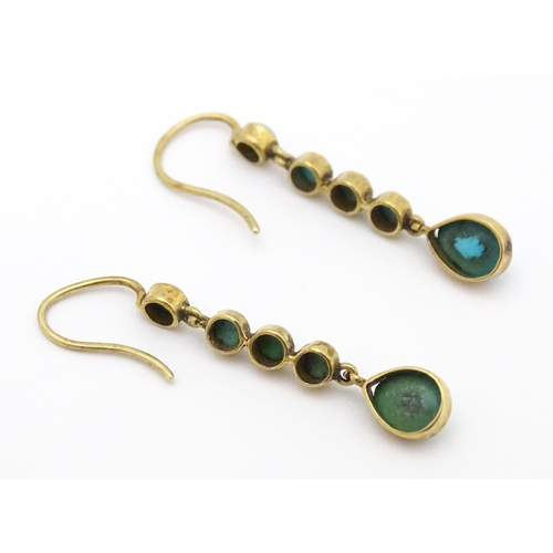 713 - A pair of gold drop earrings set with turquoise. 1 1 /4