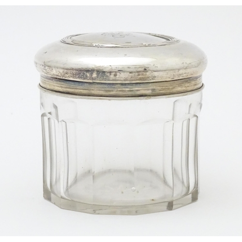 400 - A glass dressing table pot of circular form with Continental .800 silver lid. Approx. 3