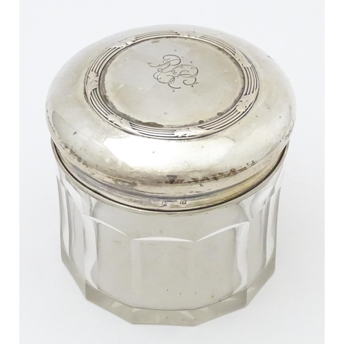 400 - A glass dressing table pot of circular form with Continental .800 silver lid. Approx. 3