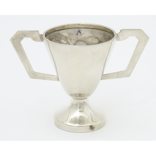 405 - An Art Deco silver trophy cup with twin handles. Hallmarked Birmingham 1937 maker David Hollander & ... 