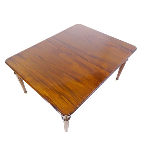 1433 - A late 20thC mahogany dining table with two additional leaves. The moulded table top raised on four ... 