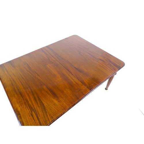 1433 - A late 20thC mahogany dining table with two additional leaves. The moulded table top raised on four ... 
