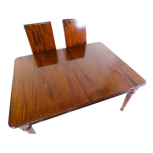 1433 - A late 20thC mahogany dining table with two additional leaves. The moulded table top raised on four ... 