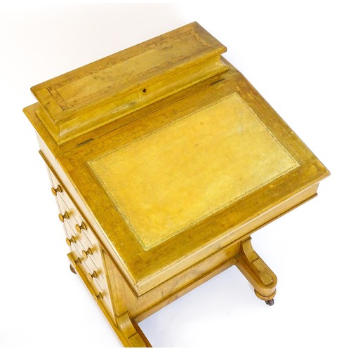 1440 - A late 19thC walnut Davenport with a fitted writing compartment to the top and an inset leather writ... 