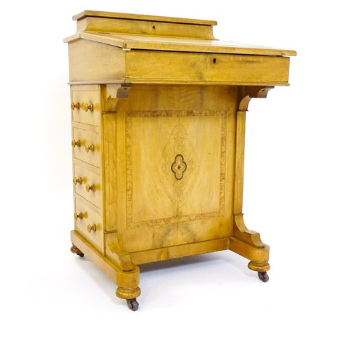 1440 - A late 19thC walnut Davenport with a fitted writing compartment to the top and an inset leather writ... 