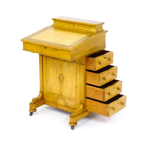 1440 - A late 19thC walnut Davenport with a fitted writing compartment to the top and an inset leather writ... 