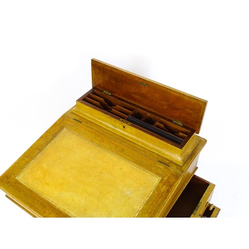 1440 - A late 19thC walnut Davenport with a fitted writing compartment to the top and an inset leather writ... 