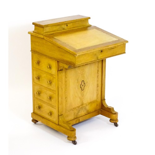 1440 - A late 19thC walnut Davenport with a fitted writing compartment to the top and an inset leather writ... 