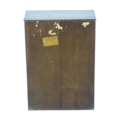 1442 - A late Georgian table top cabinet with an astragal glazed door above three short drawers raised on s... 