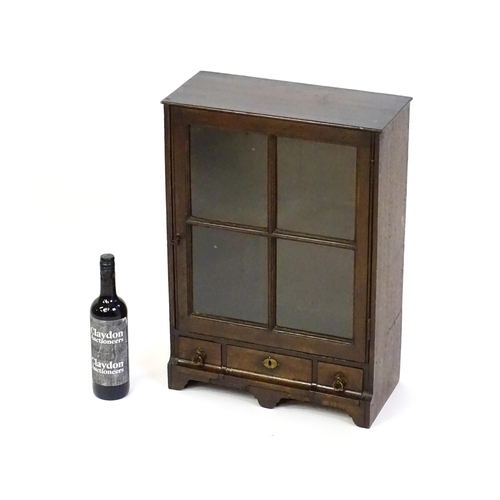 1442 - A late Georgian table top cabinet with an astragal glazed door above three short drawers raised on s... 